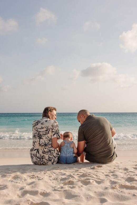 Nigel, Trisha and their little one on the beach in Aruba